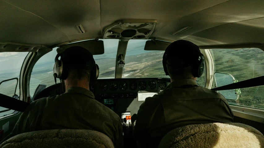 a couple of men flying a small plane