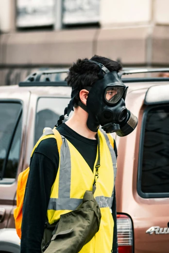 a man wearing a yellow vest and a mask