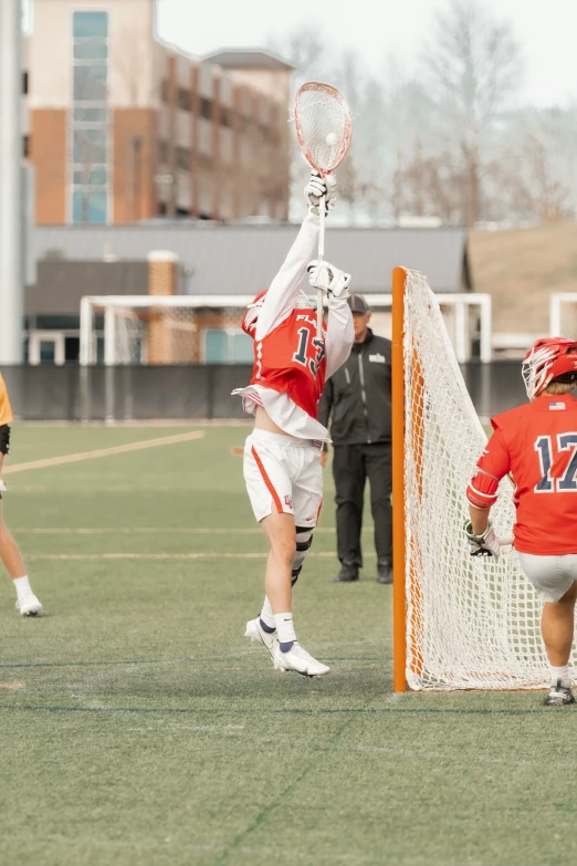 a group of lacrosse players standing on a field