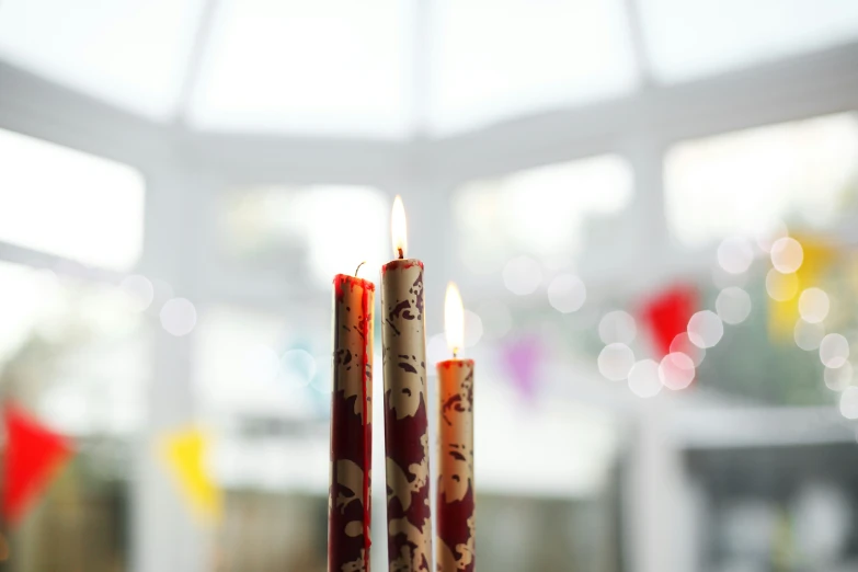 three candles that are sitting in a cup