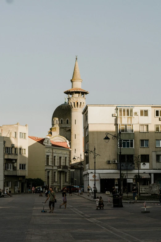 a street with various buildings and a clock tower