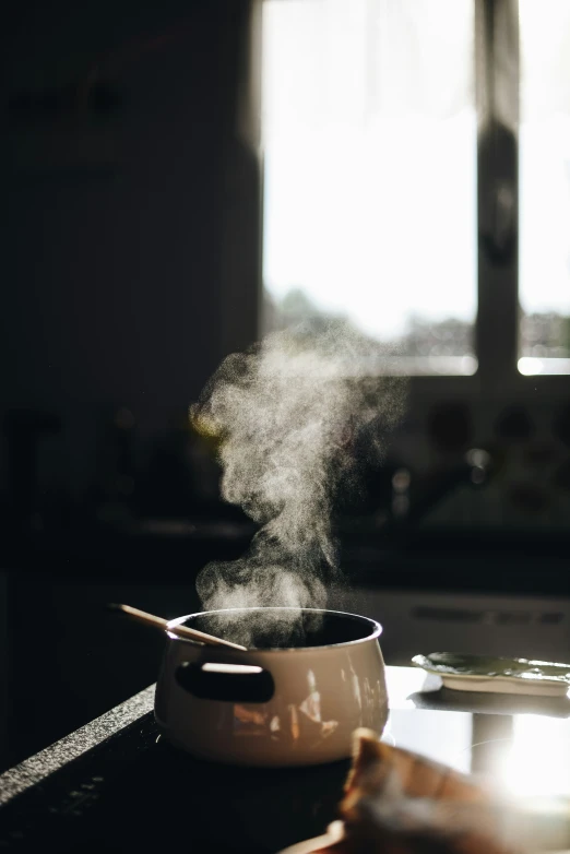 a pot with steam coming out on the stove top