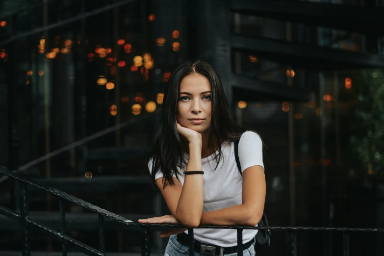 a woman leans her head on the railing