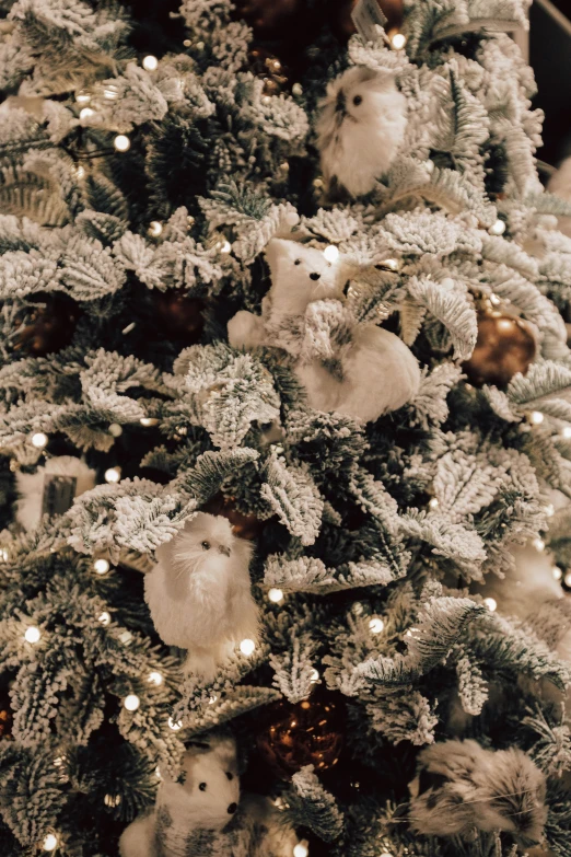 a christmas tree with stuffed animals and white lights