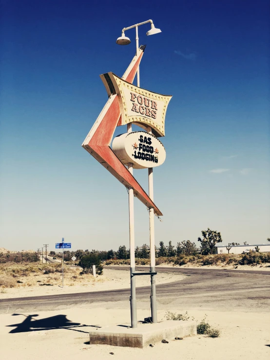 a neon sign on a small metal pole