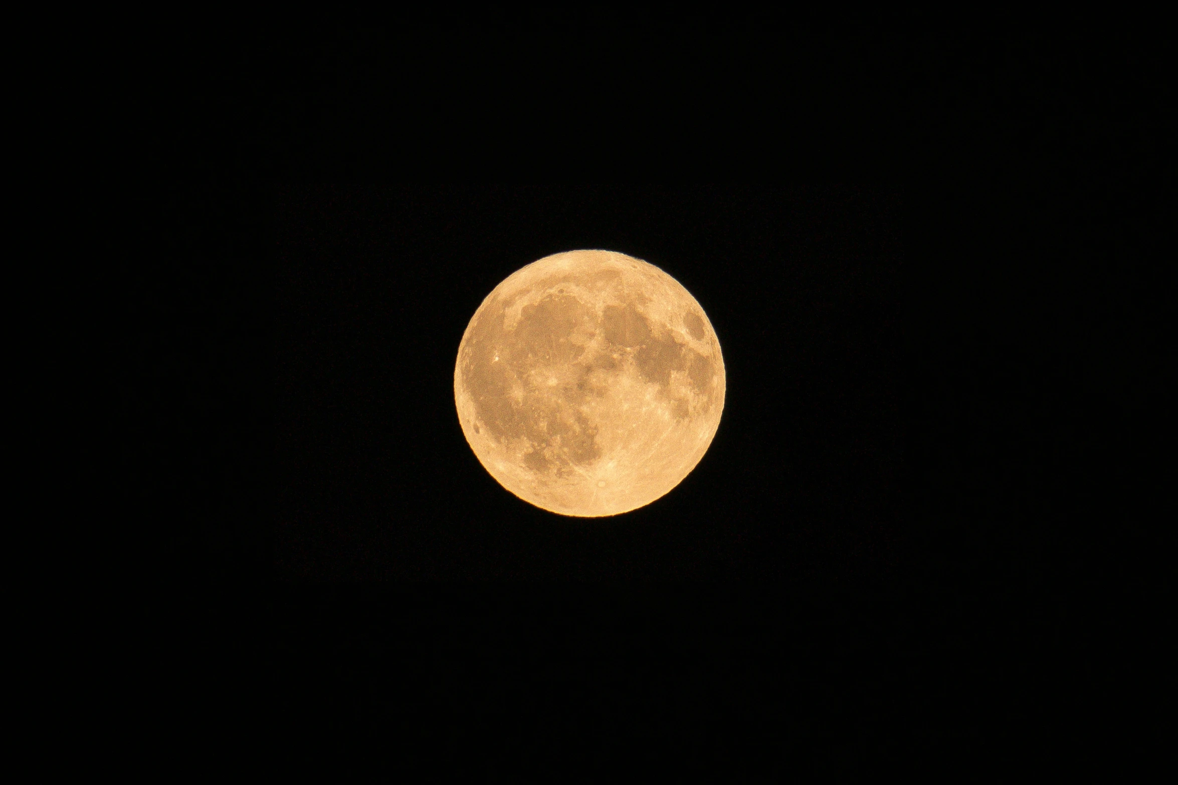 a very big full moon in the sky with no clouds