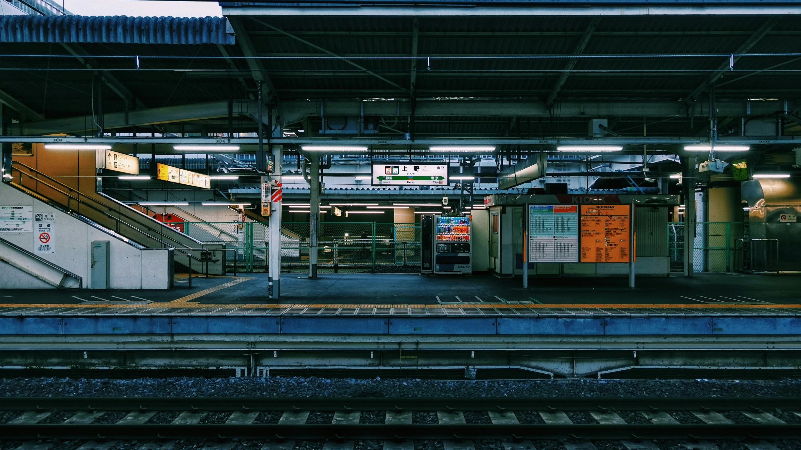 a train platform with many different tracks at night