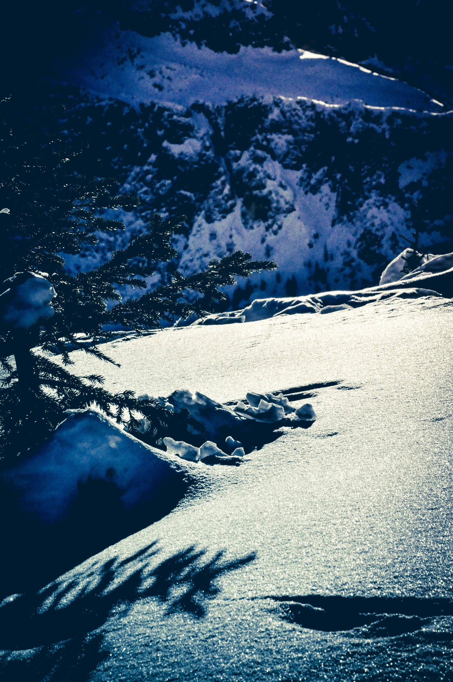 a snowboarder skis on the snow next to a snowy slope