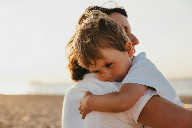 a woman holding a small child in her arms