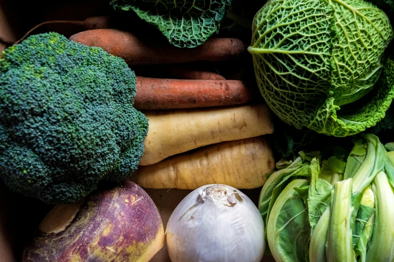 various vegetables are in a pile in a box