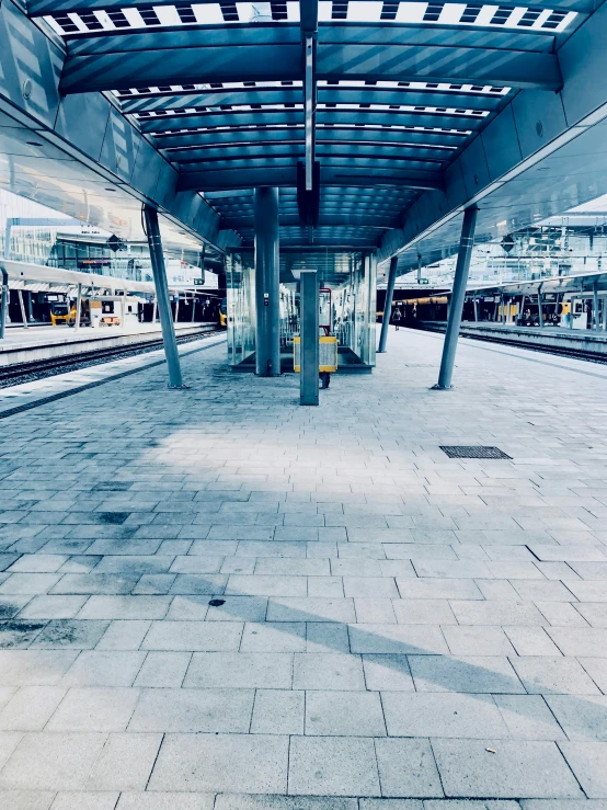 a platform of an indoor train station with no people
