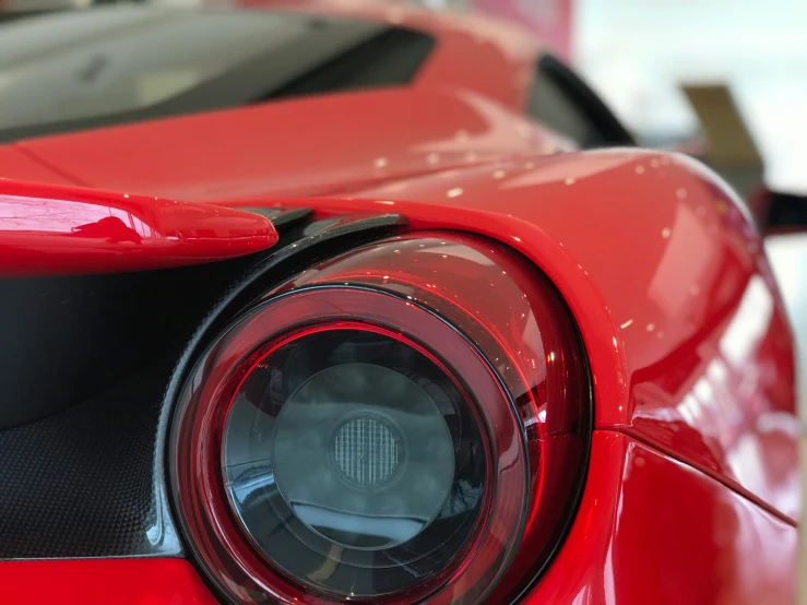 the front light of a sports car sits on display