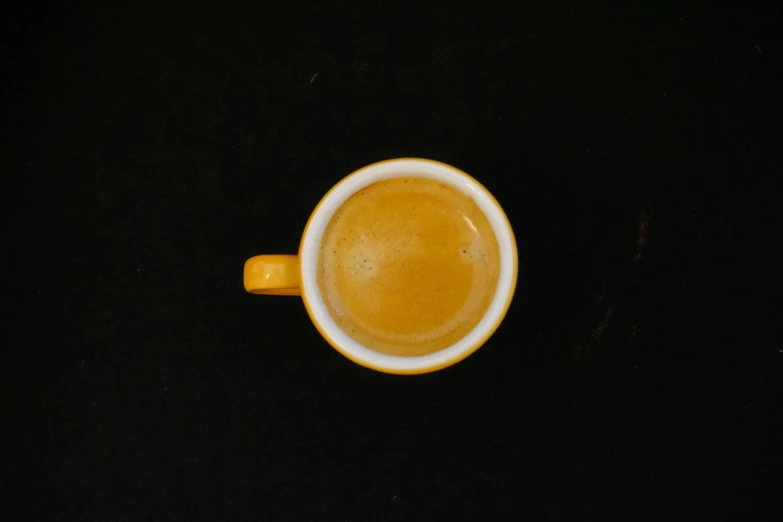 an orange mug filled with a liquid