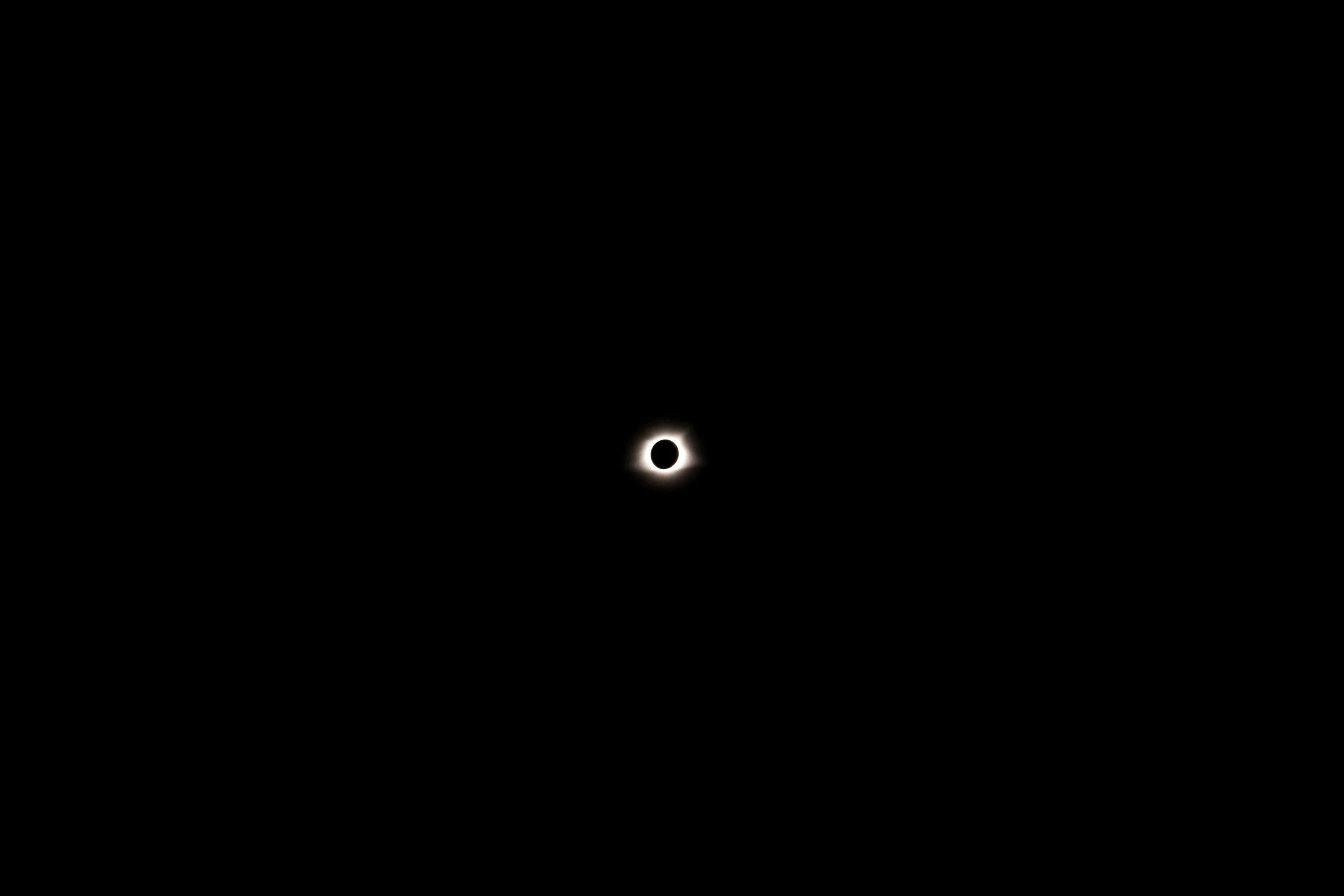 a small, black object in the middle of a dark sky