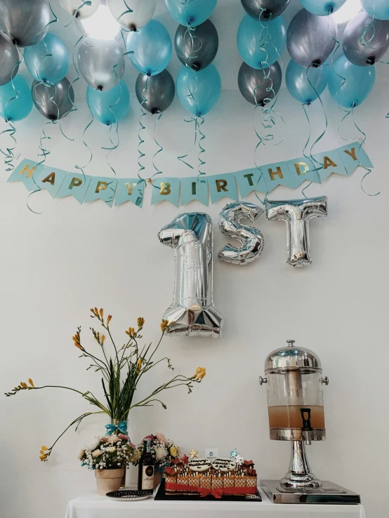 blue balloons, silver foil balloons, and a happy 21st birthday banner