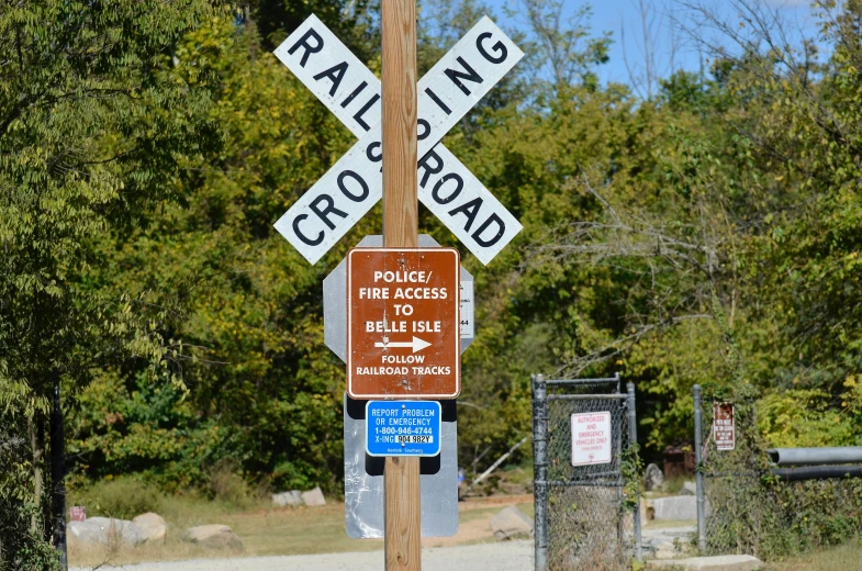 a railroad crossing sign is posted at the roadside