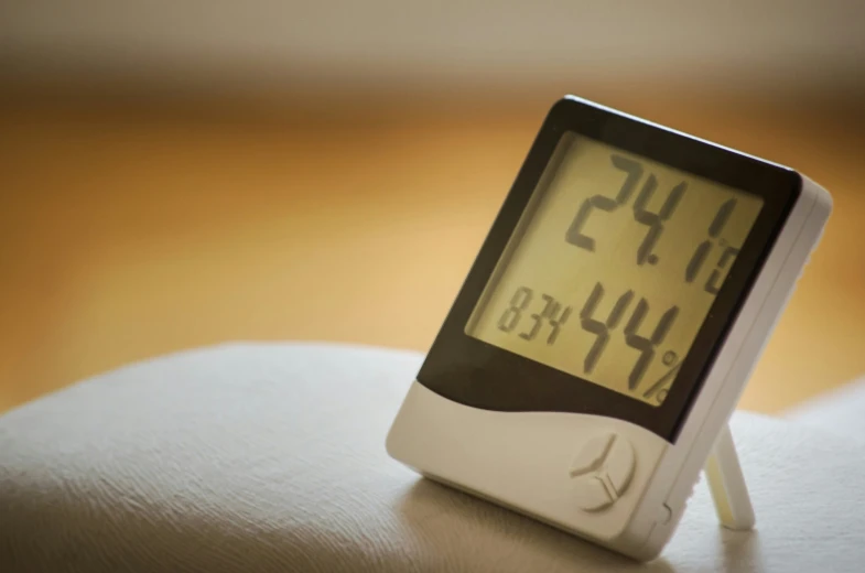 this is an alarm clock sitting on a bed