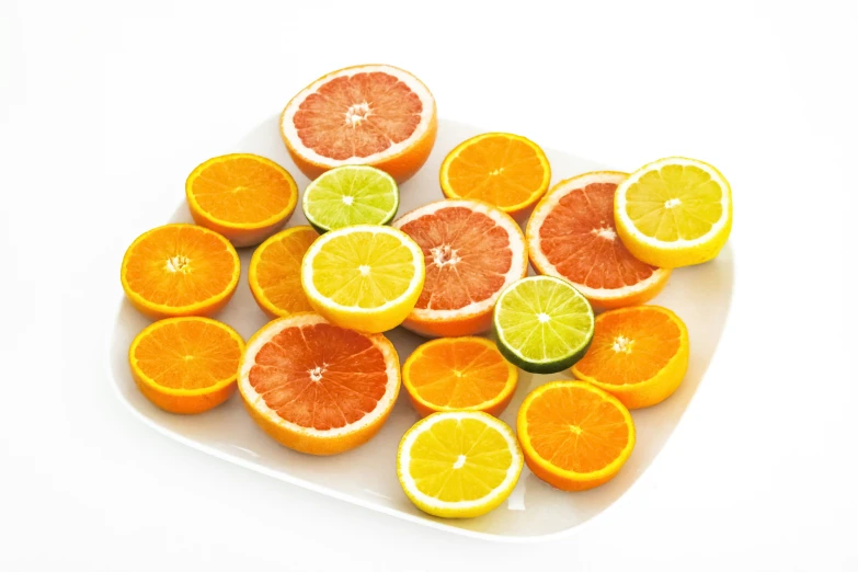 a bunch of orange slices are arranged on a white platter