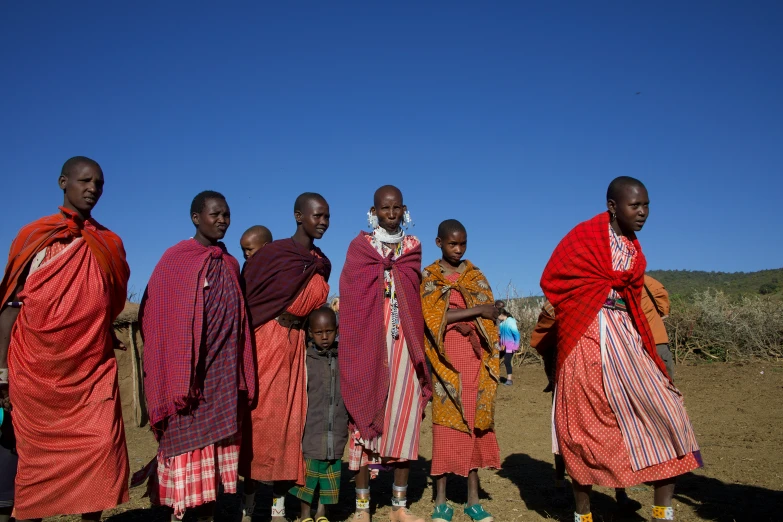 a group of men in colorful costumes with a man standing behind them