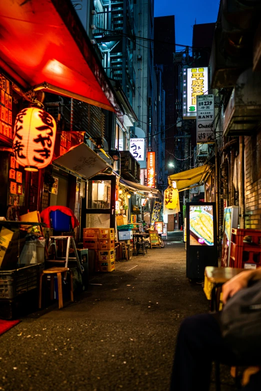 a man sitting in a chair outside of an asian street