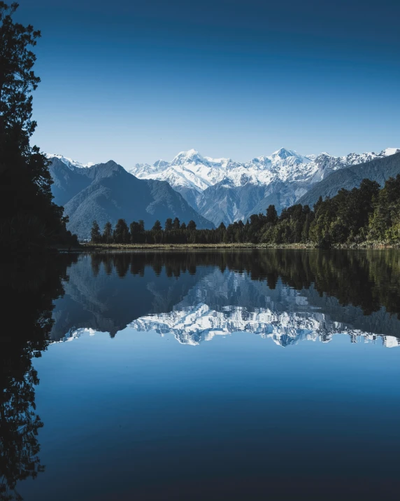 view of a mountain and body of water with trees