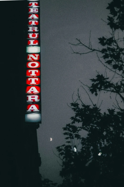 a street sign is glowing on the night sky