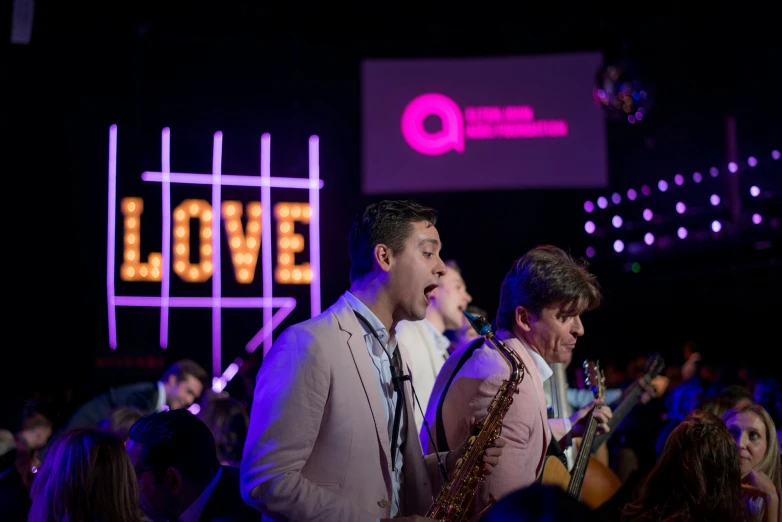 a couple of men standing next to each other on stage