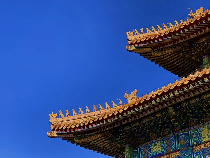 a tall oriental tower towering over a blue sky