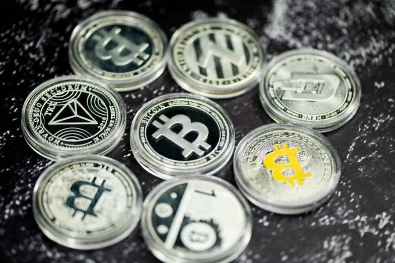 some different coins with logos on them sitting on a table