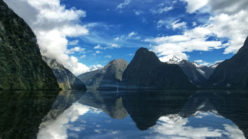 a mountain range is in the foreground, and a body of water is at the bottom