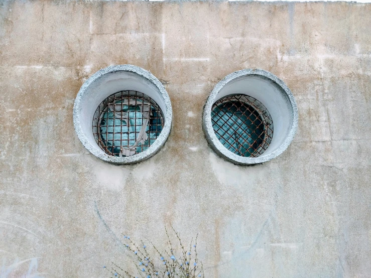 two round windows with glass embedded in them
