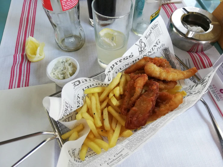 a meal consisting of fried food and fries on a tray