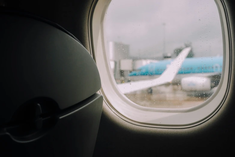 a window view of an airport, with an airplane in the background