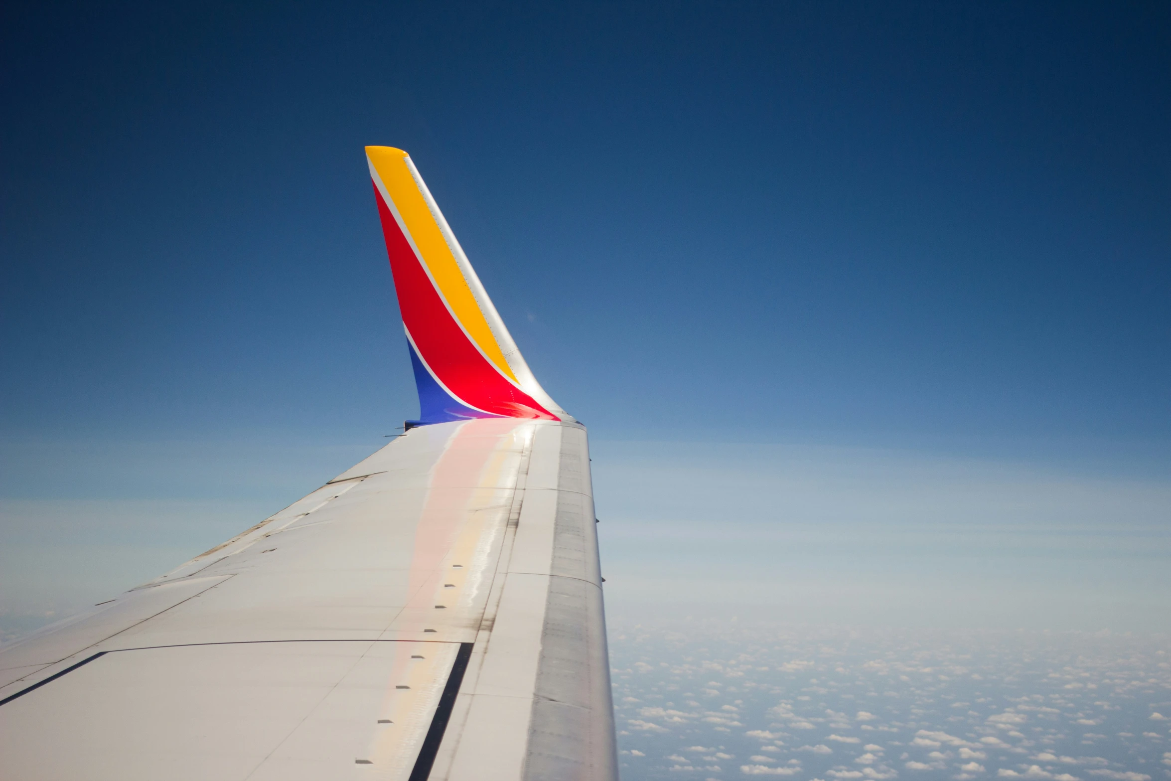 a colorful airplane tail flying in the air