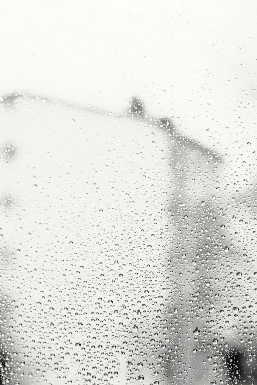 a person walking in the rain on a street