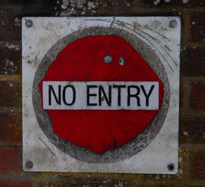 a sign on the side of a building stating that there is no entry