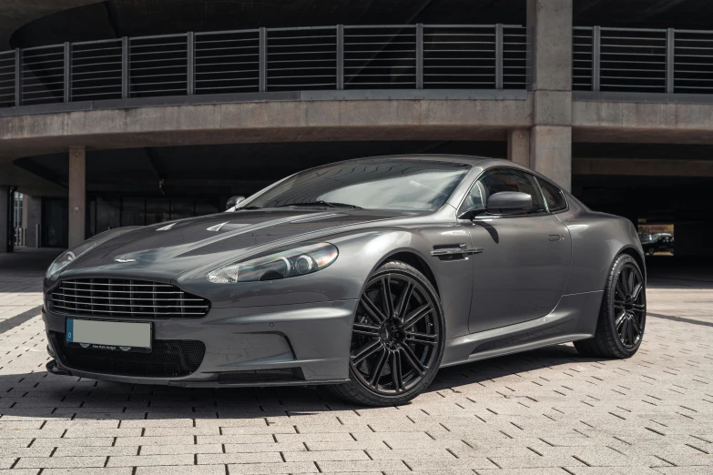 a grey sports car is parked in a driveway