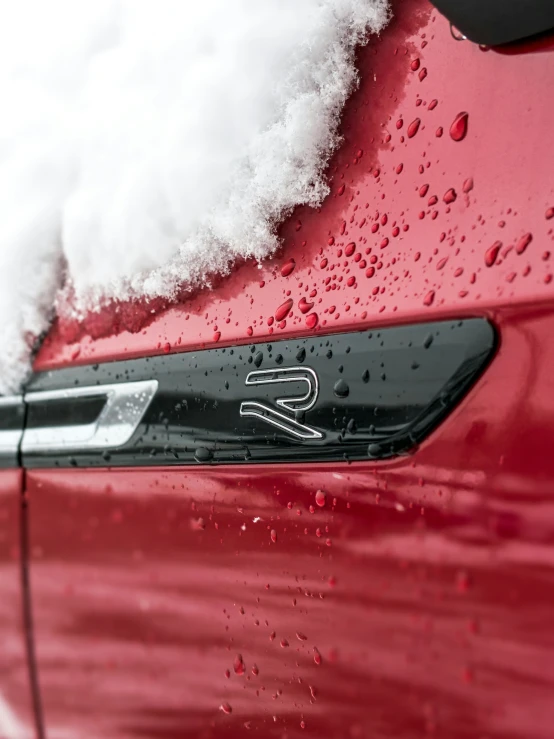 a close up view of the front bumper seal of a car covered in snow