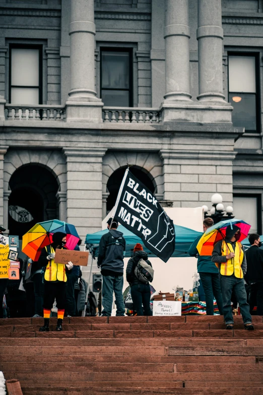 a group of people holding signs on steps