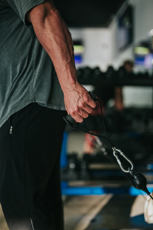 a person pulling a piece of material with a tool