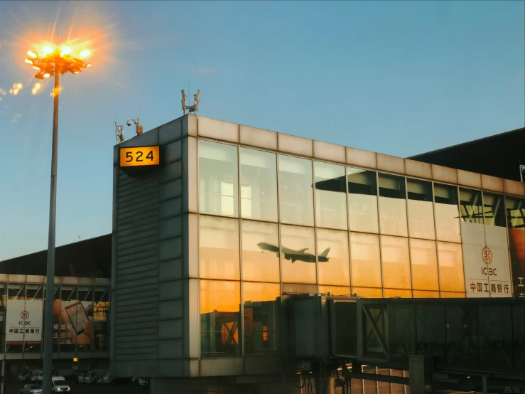 an airport with a glass building and a street light