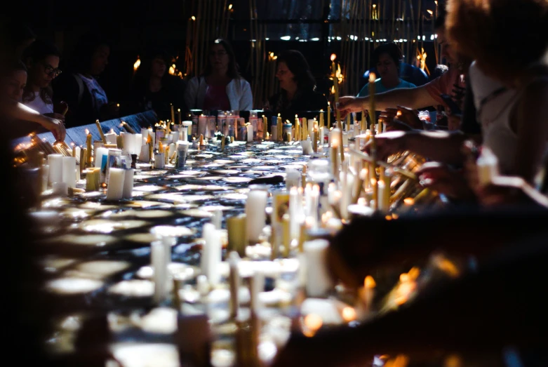 many candles are lit in a long table