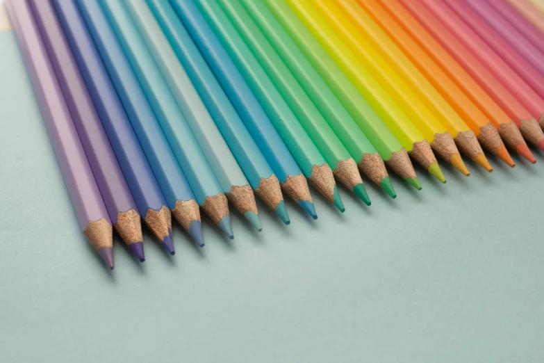 colorful pencils with different colored tips lined up in a rainbow