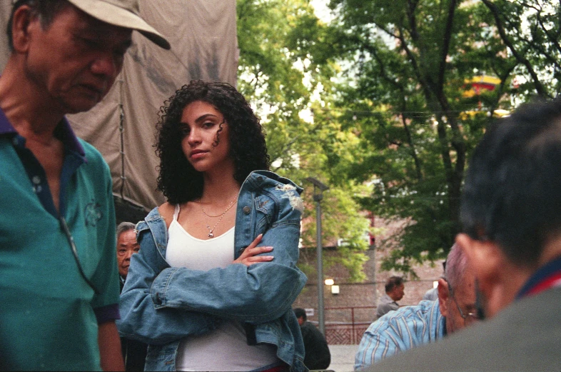 a woman standing next to a man near trees