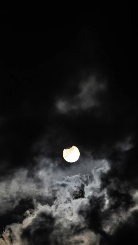 the moon with clouds all around it