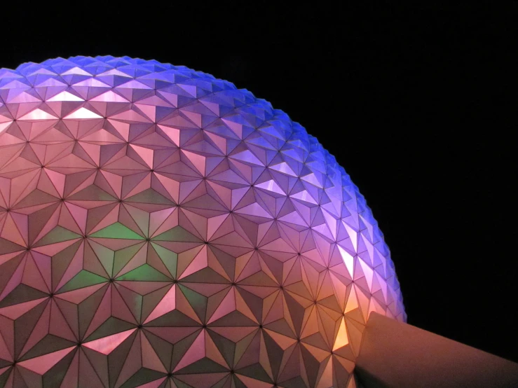 a spaceship ball sitting next to an orange and purple sphere