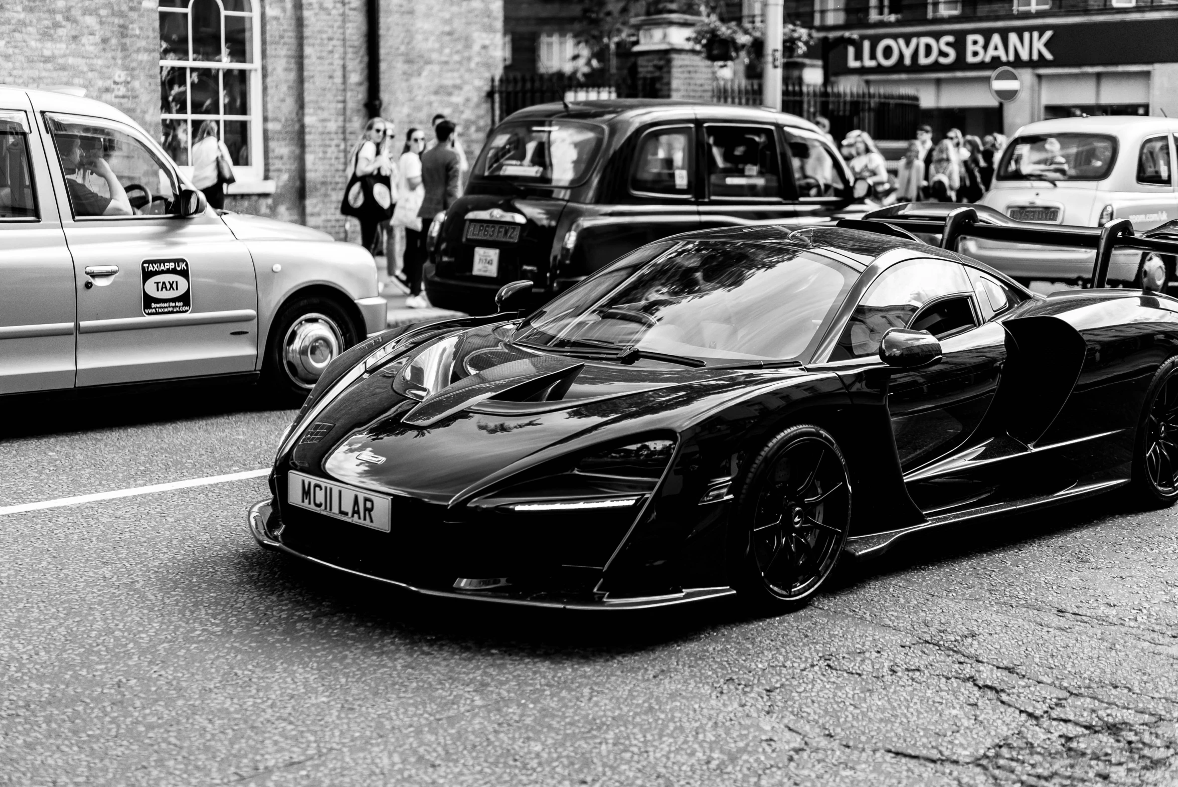 a black supercars parked on the side of the street