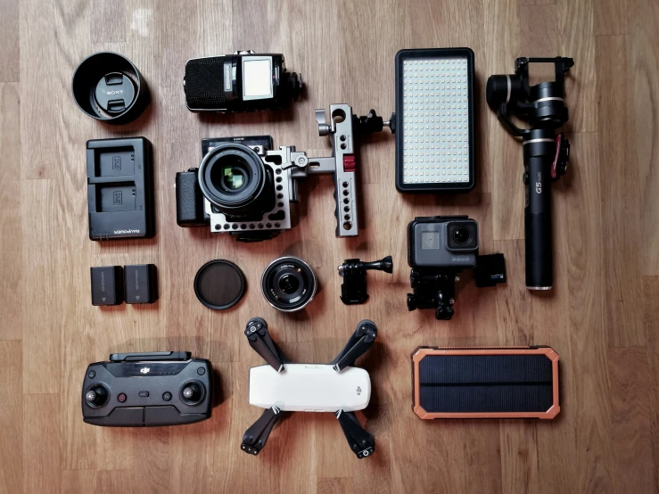 camera equipment laying out on a wooden floor