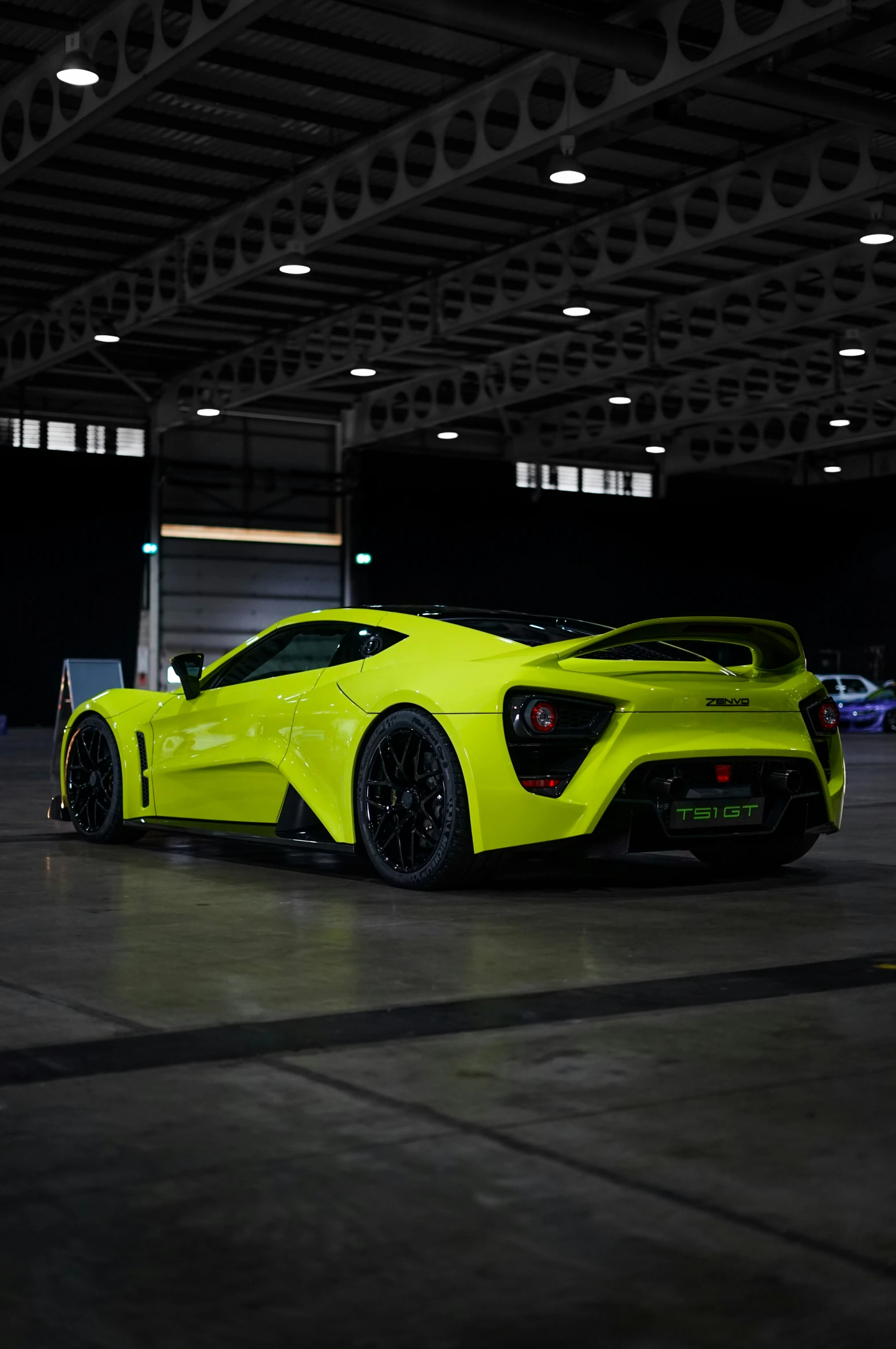 a yellow sports car parked in an empty garage