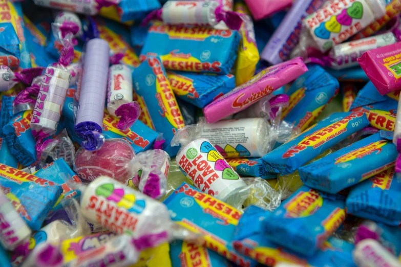 many blue, yellow and pink candy bar tubes